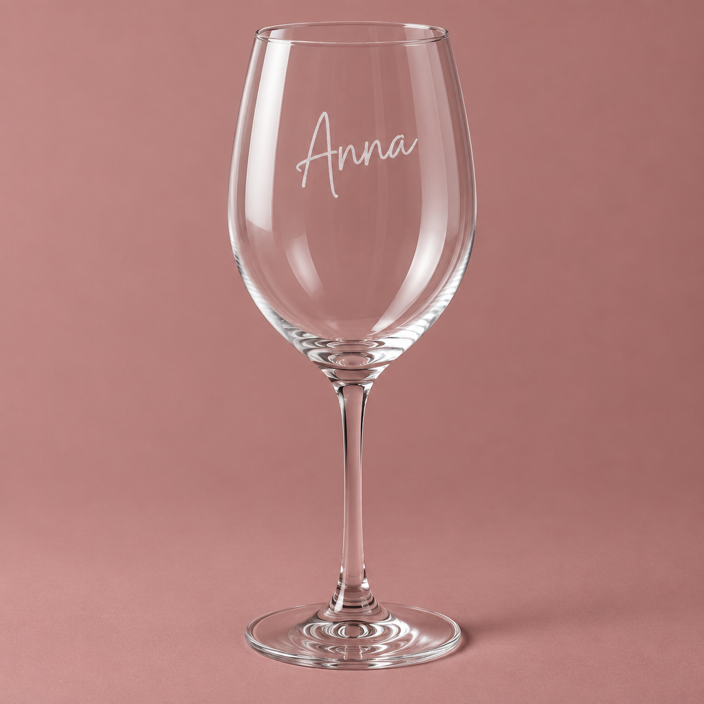Weinglas mit Name Anna vor roséfarbenem Hintergrund